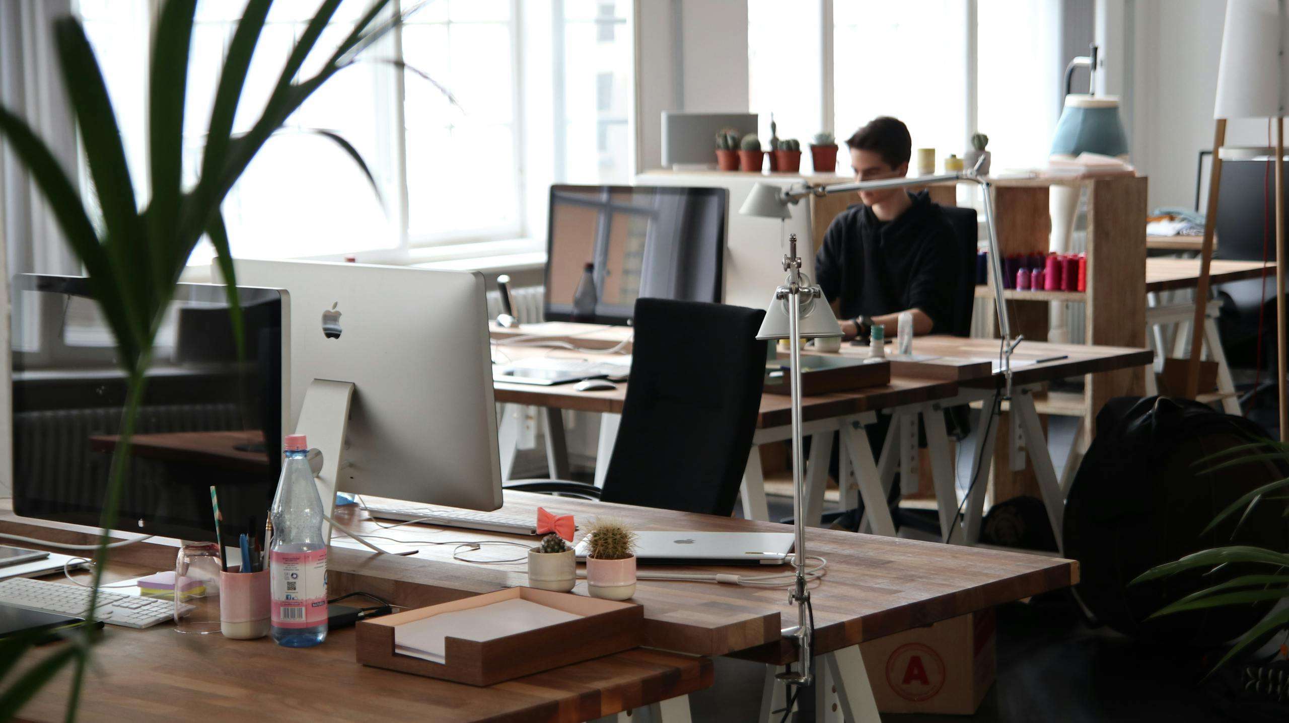 Man Sitting in Front of Computer From improving product aesthetics to enhancing user experiences, here are several types of businesses that stand to gain from the services of an automotive design company.